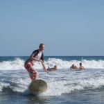 woman surfing on a tropicaal sea beach
