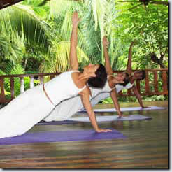 women doing yoga on wooden yoga deck