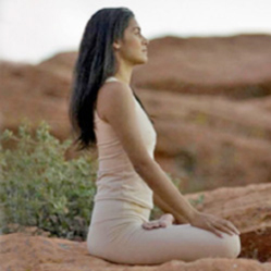 woman doing meditation on the tip of mountain