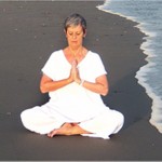 woman meditating besides sea beach