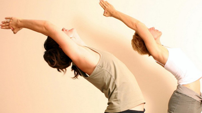 women practicing vinyasa flow yoga
