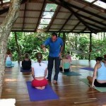 group of people practicing yoga with instructor