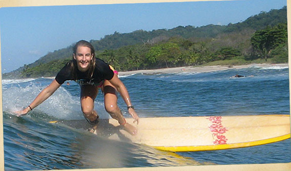 woman surfing on tropical sea beach